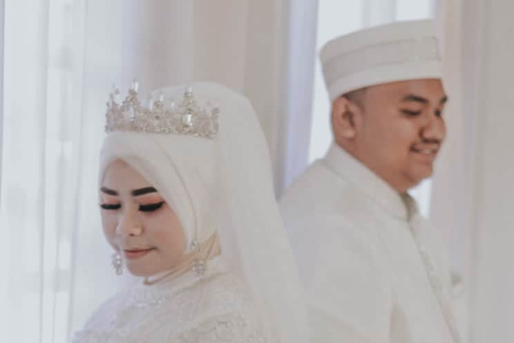 Muslim wedding couple with their backs to each other