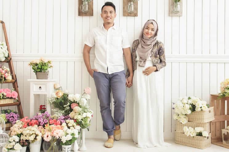 Married muslim couple surrounded by flowers